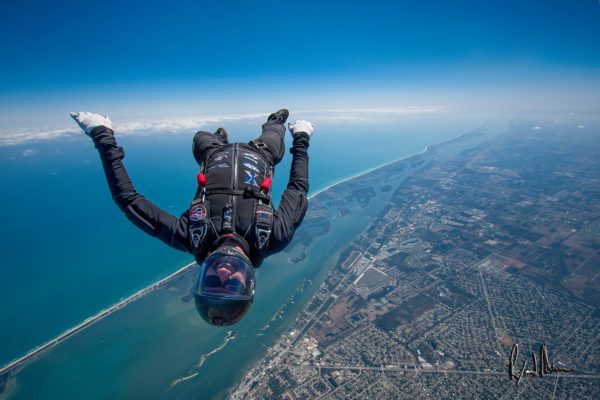 Rook Nelson skydiving over the coastline with Sun Path skydiving rig