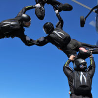 skydiving team, SDC Rhythm XP in freefall wearing matching Sun Path rigs